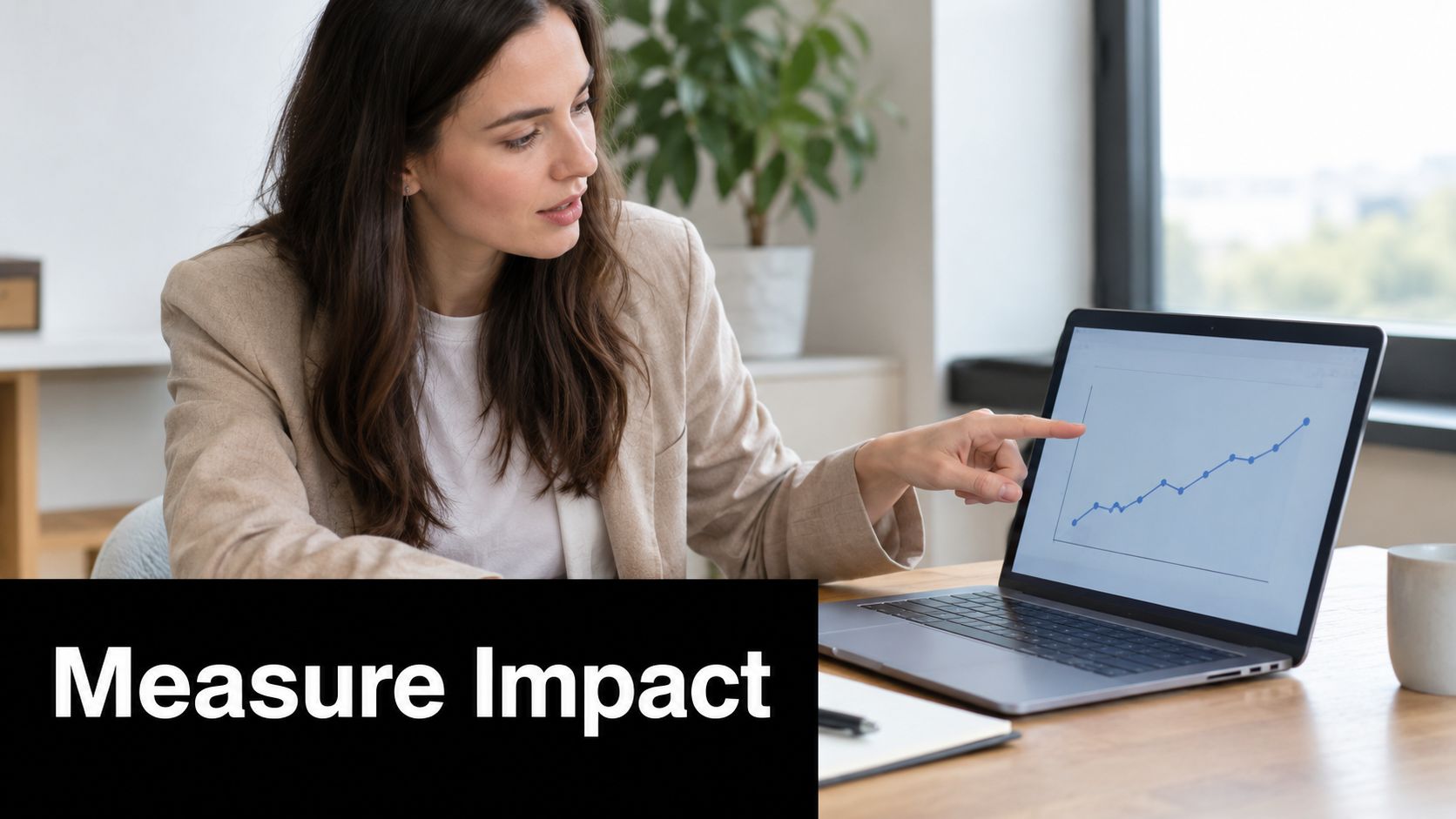 A businesswoman points at an upward trending graph on a laptop screen to illustrate positive performance.