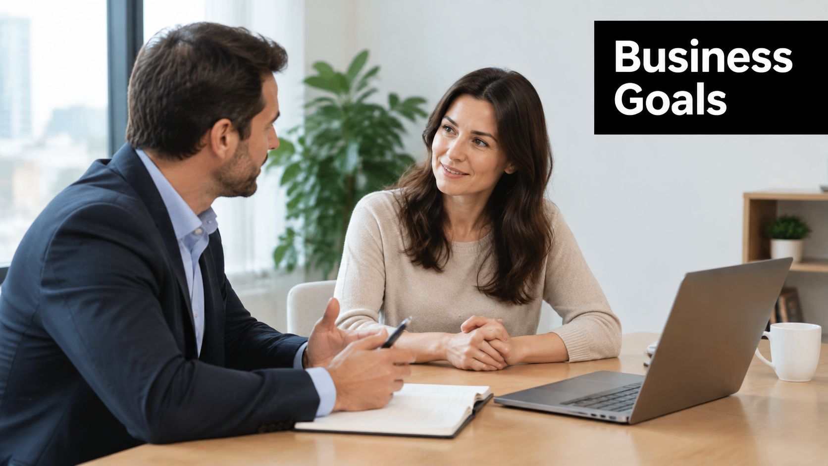 A professional man and woman having a productive business discussion in a bright, modern office setting.