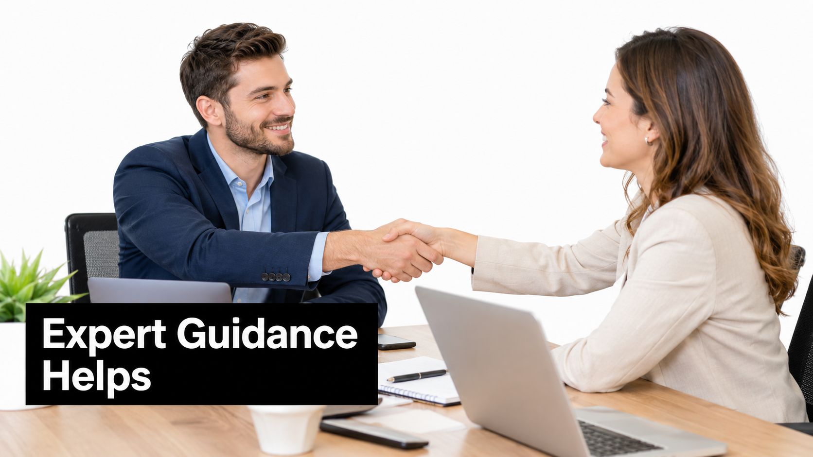 A professional man and woman shaking hands across an office desk, symbolizing business agreement and expert guidance.